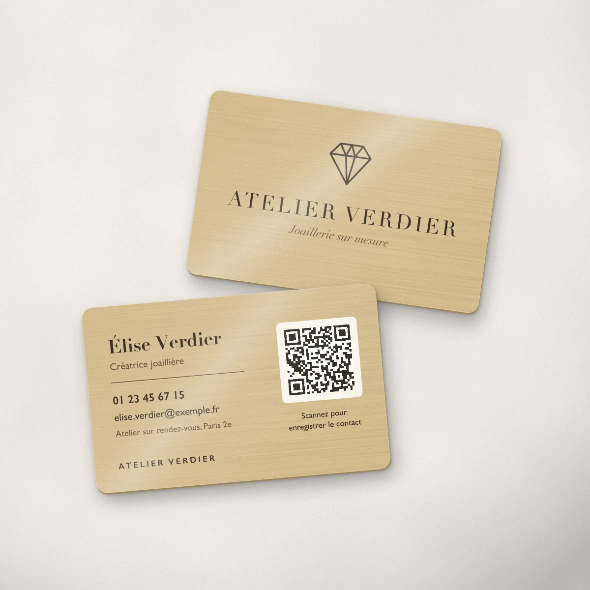 Carte de visite métallique en finition or champagne, imprimée pour une enseigne fictive, avec nom, fonction et QR code