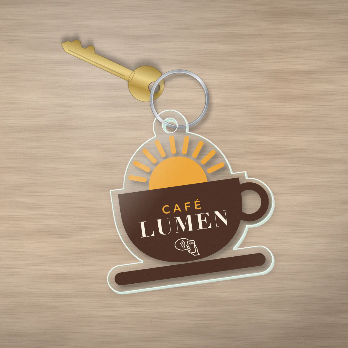 Porte-clé NFC en acrylique découpé à la forme du logo du café fictif Café Lumen, imprimé en couleur, avec anneau métallique
